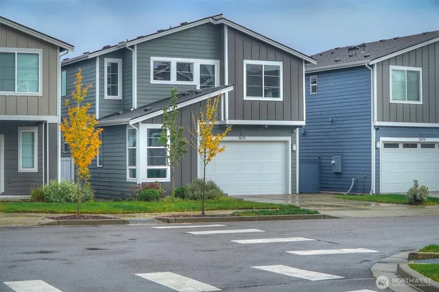a front view of a house with a yard and garage