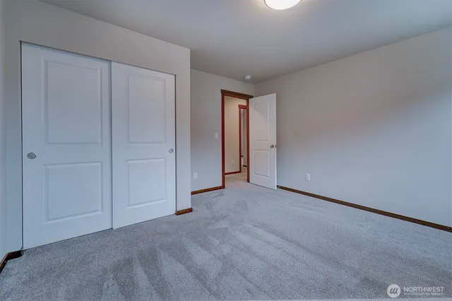 an empty room with closet area