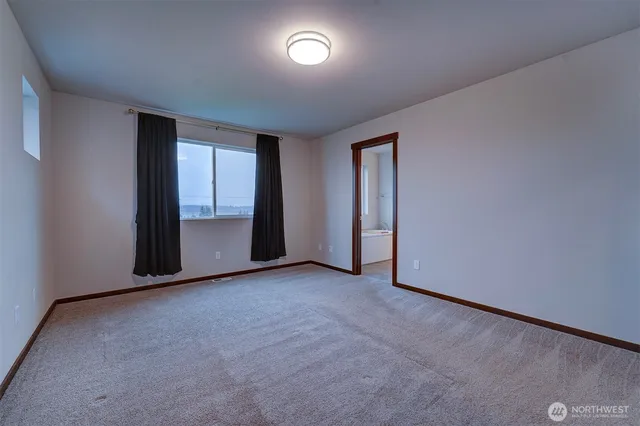 an empty room with sliding door and windows