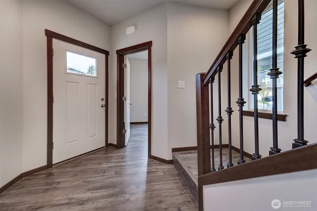 a view of an entryway with wooden floor and door