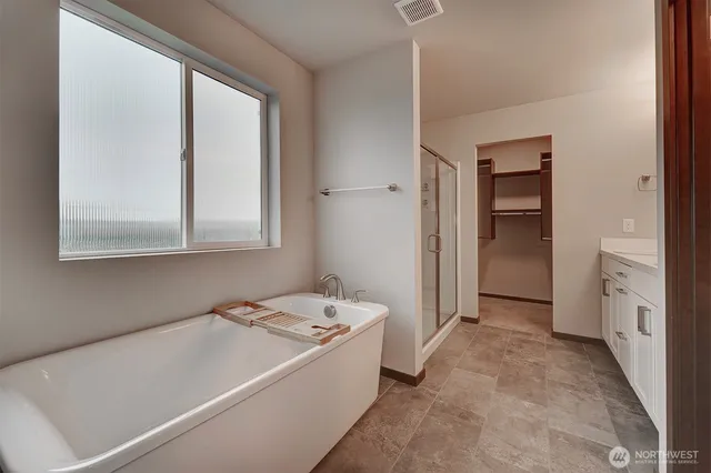a view of a bathroom with tub and sink