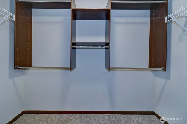 a spacious bathroom with a double vanity sink a mirror and a shower