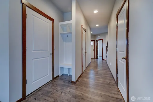 a view of a hallway with wooden floor