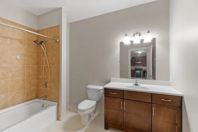 a bathroom with a sink toilet a mirror and shower