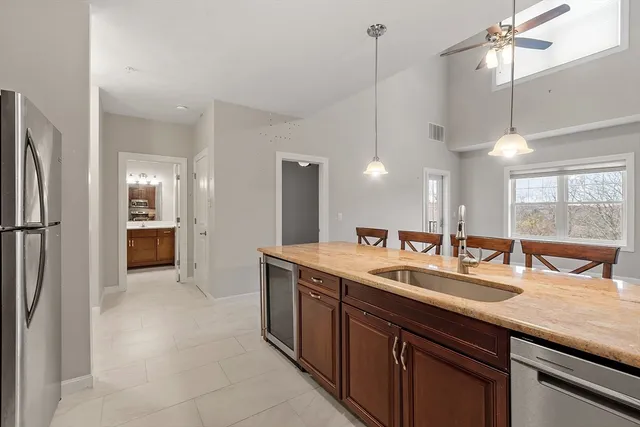 a kitchen with a sink and refrigerator