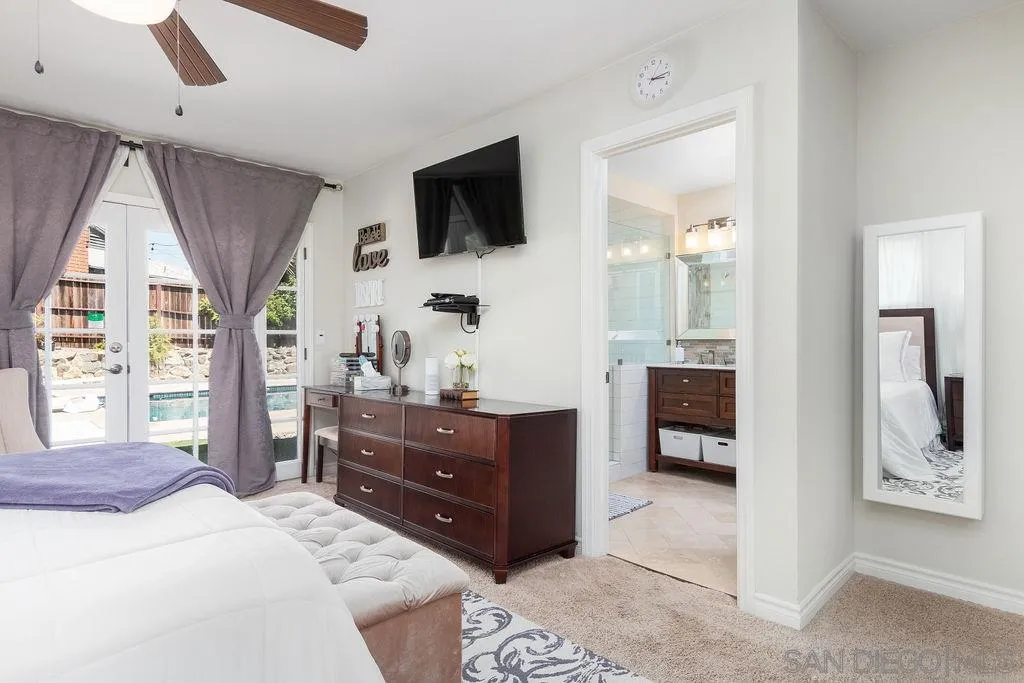 6205 Ruby Lake Avenue San Diego, CA 92119 - Photo 14 of 25 a bedroom with a bed and a television