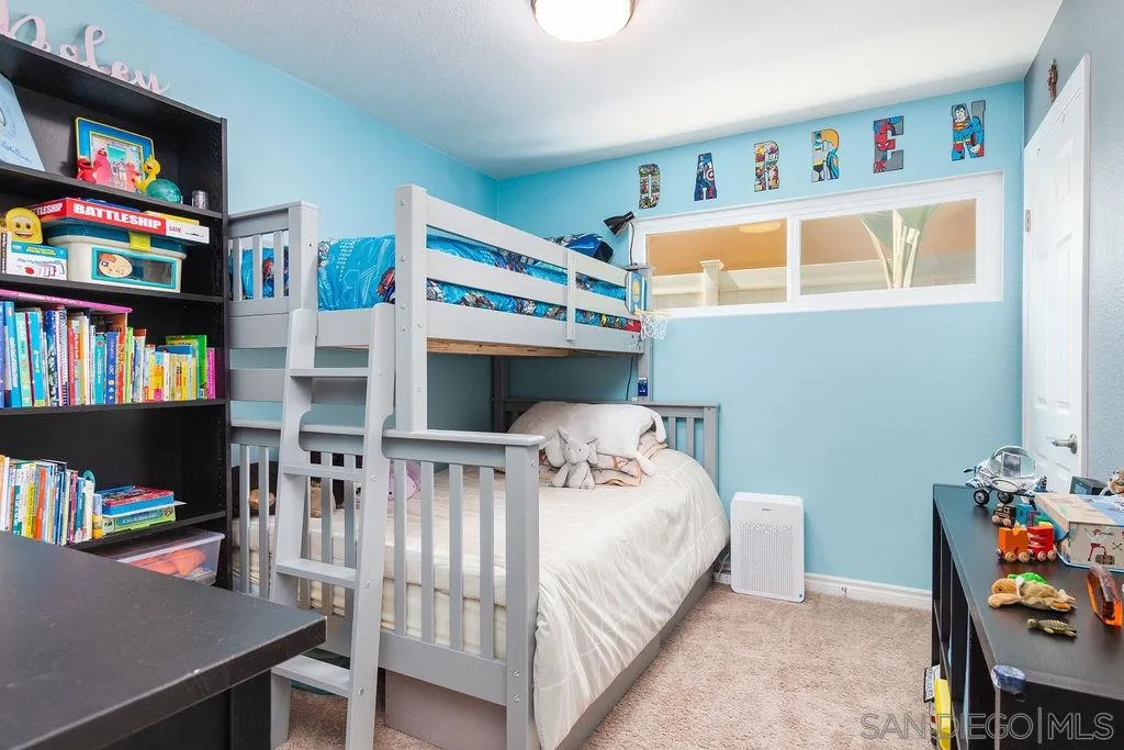 6205 Ruby Lake Avenue San Diego, CA 92119 - Photo 20 of 25 a bedroom with bed and a book shelf