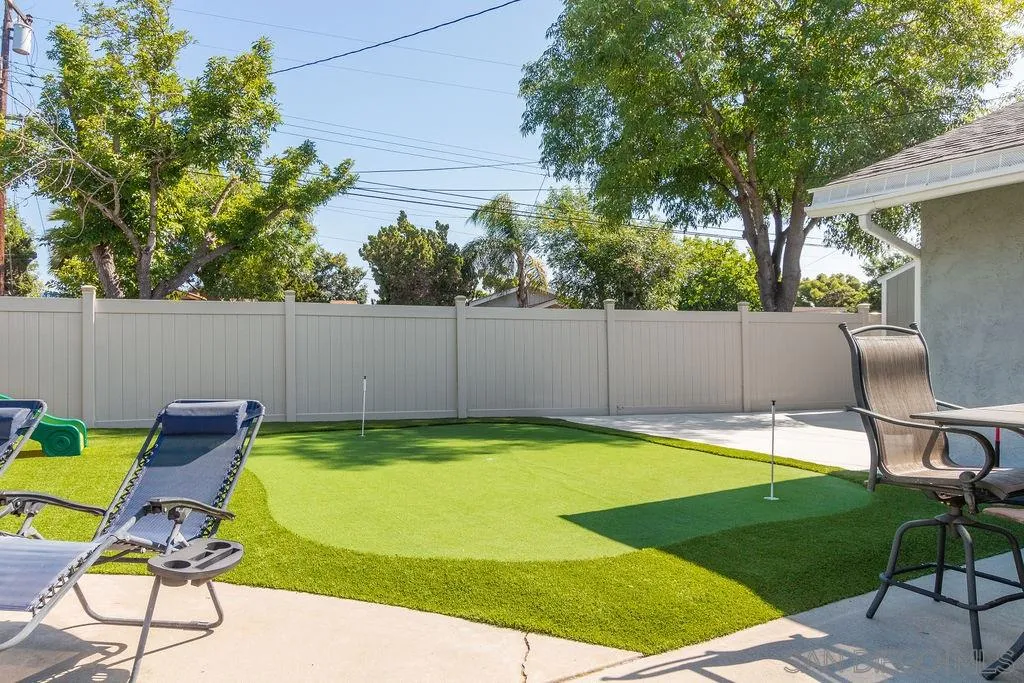 6205 Ruby Lake Avenue San Diego, CA 92119 - Photo 21 of 25 a view of a swimming pool with lawn chairs under an umbrella