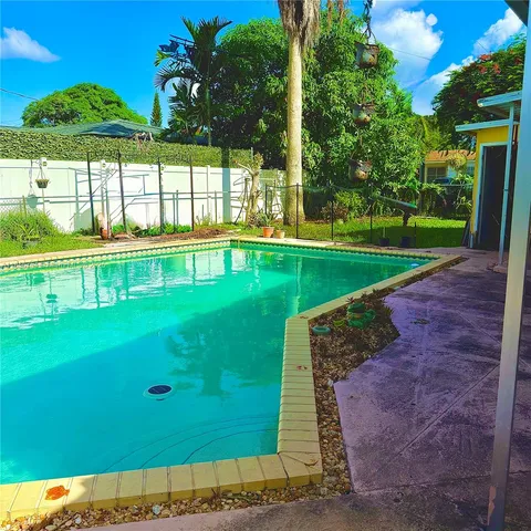 a view of a swimming pool with a yard