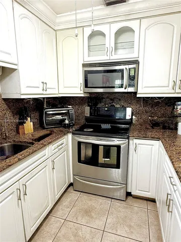 a kitchen with a stove and a microwave