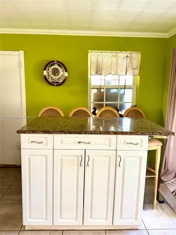 a view of a kitchen with granite countertop a sink and a window