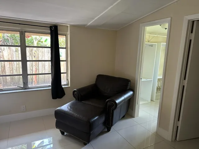 a room with a flat screen tv and a window