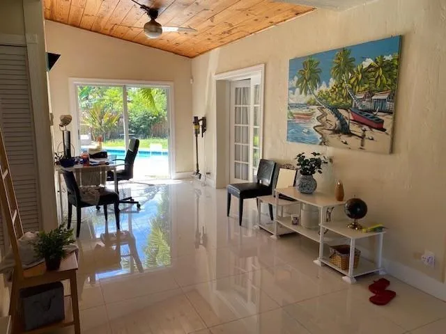 a living room with furniture and a floor to ceiling window