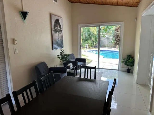 a dining room with furniture and window