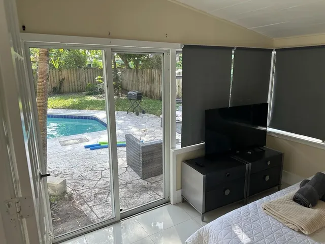 a bedroom with a bed and glass door