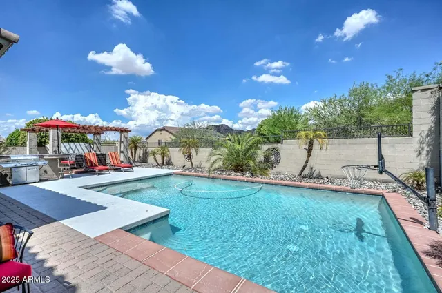 a bathroom with a tub a double vanity sink and mirror