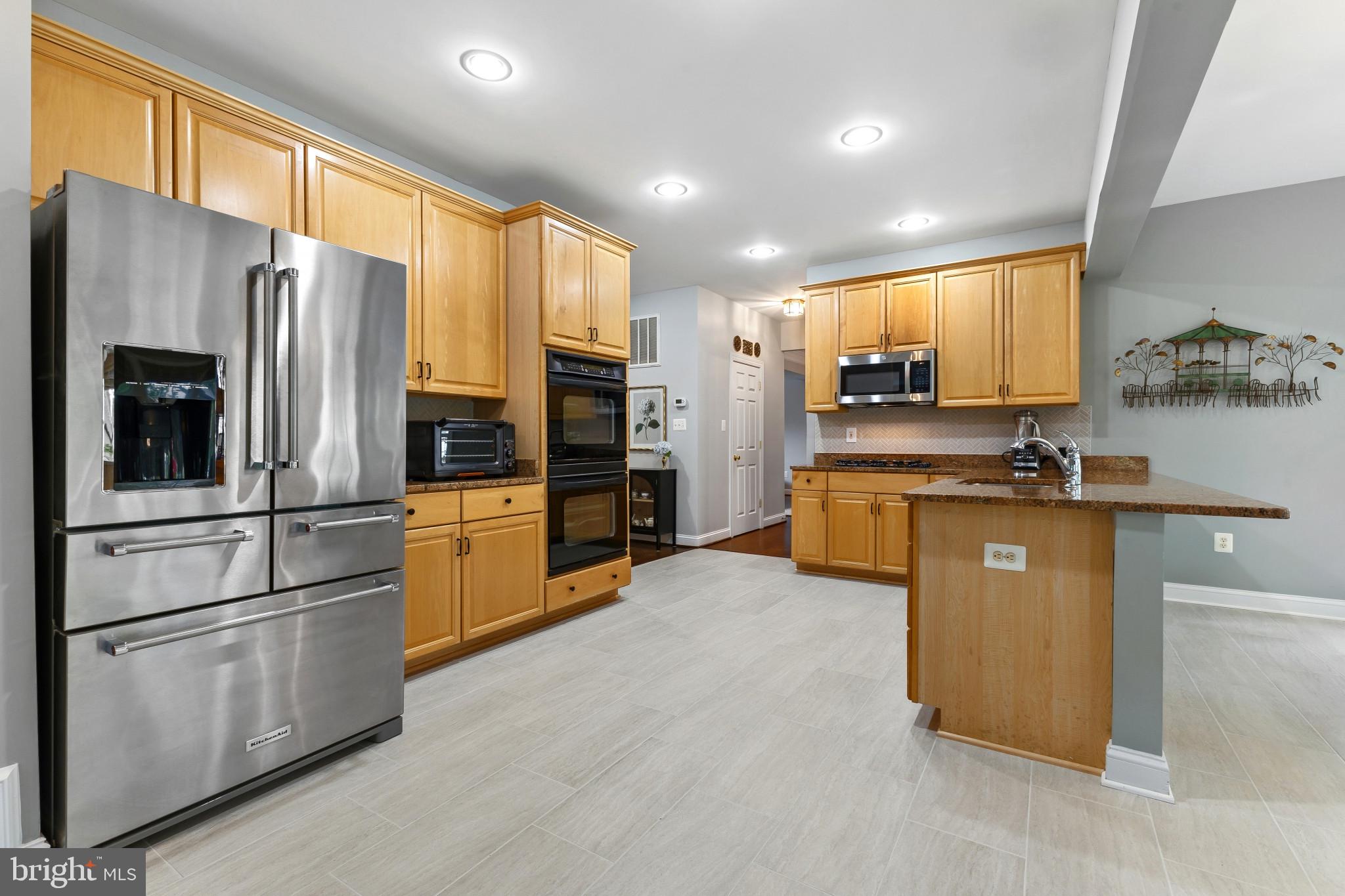 15006 Ransom Oaks Court Gainesville, VA 20155 - Photo 12 of 57 Modern kitchen with warm wood tones.