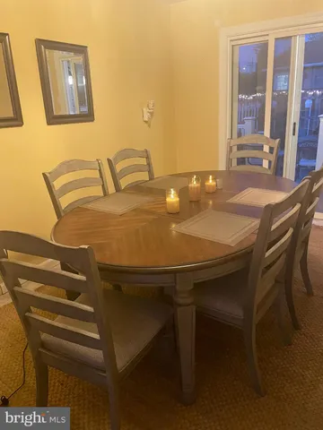a view of a dining room with furniture and window