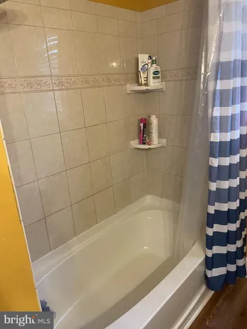a bathroom with a bathtub and a shower