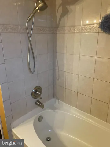 a bathroom with a bath tub with a shower