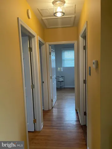 a view of a hallway with wooden floor