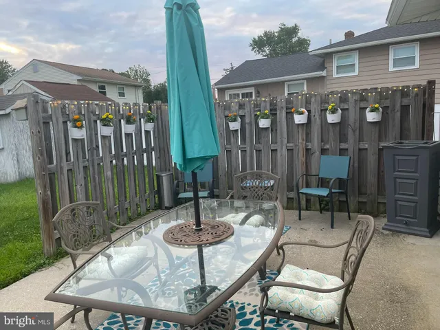 a view of a patio with table and chairs and potted plants