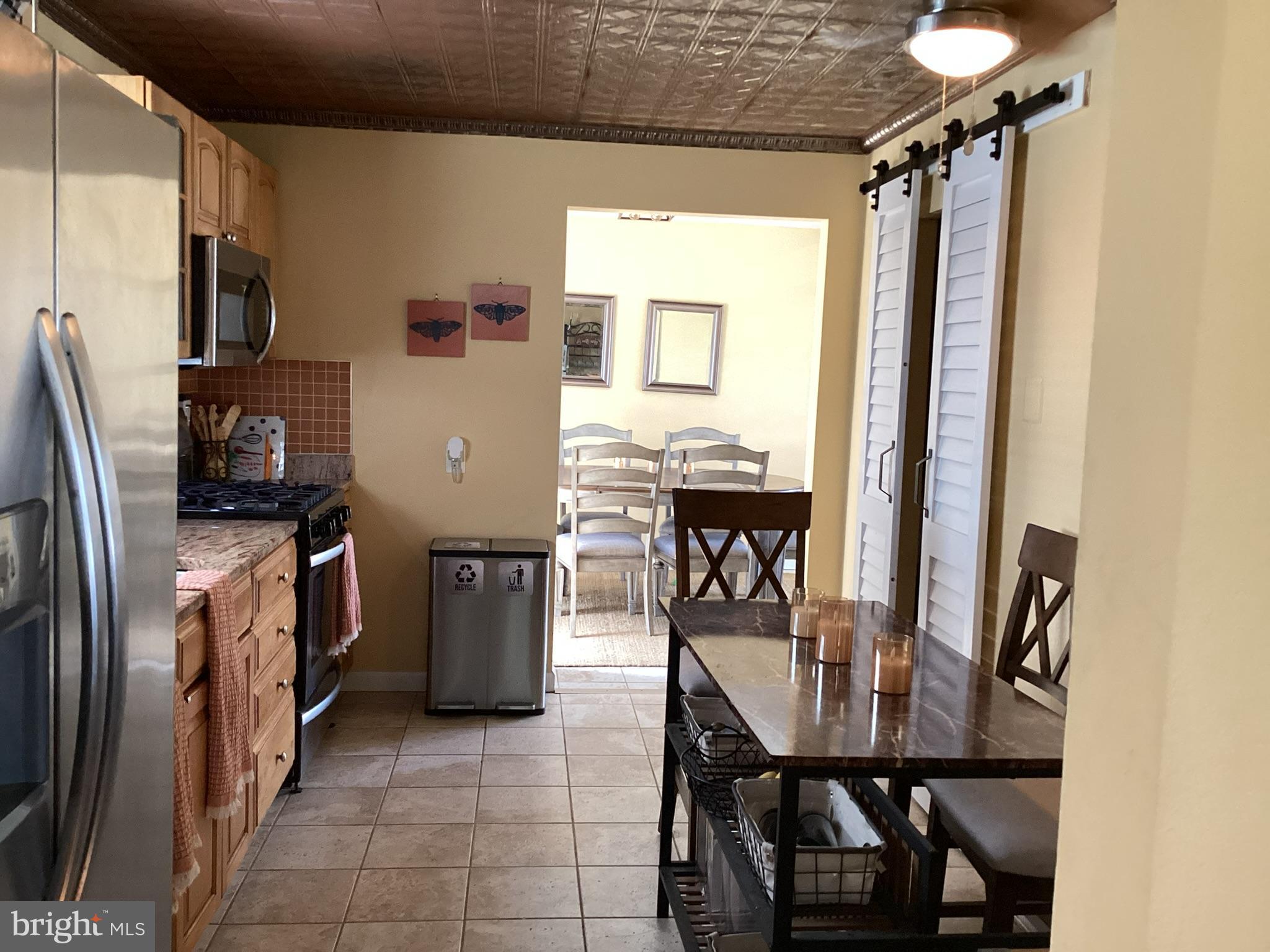1101 Prospect Lane Somerdale, NJ 08083 - Photo 6 of 41 a kitchen with a table chairs refrigerator and a window