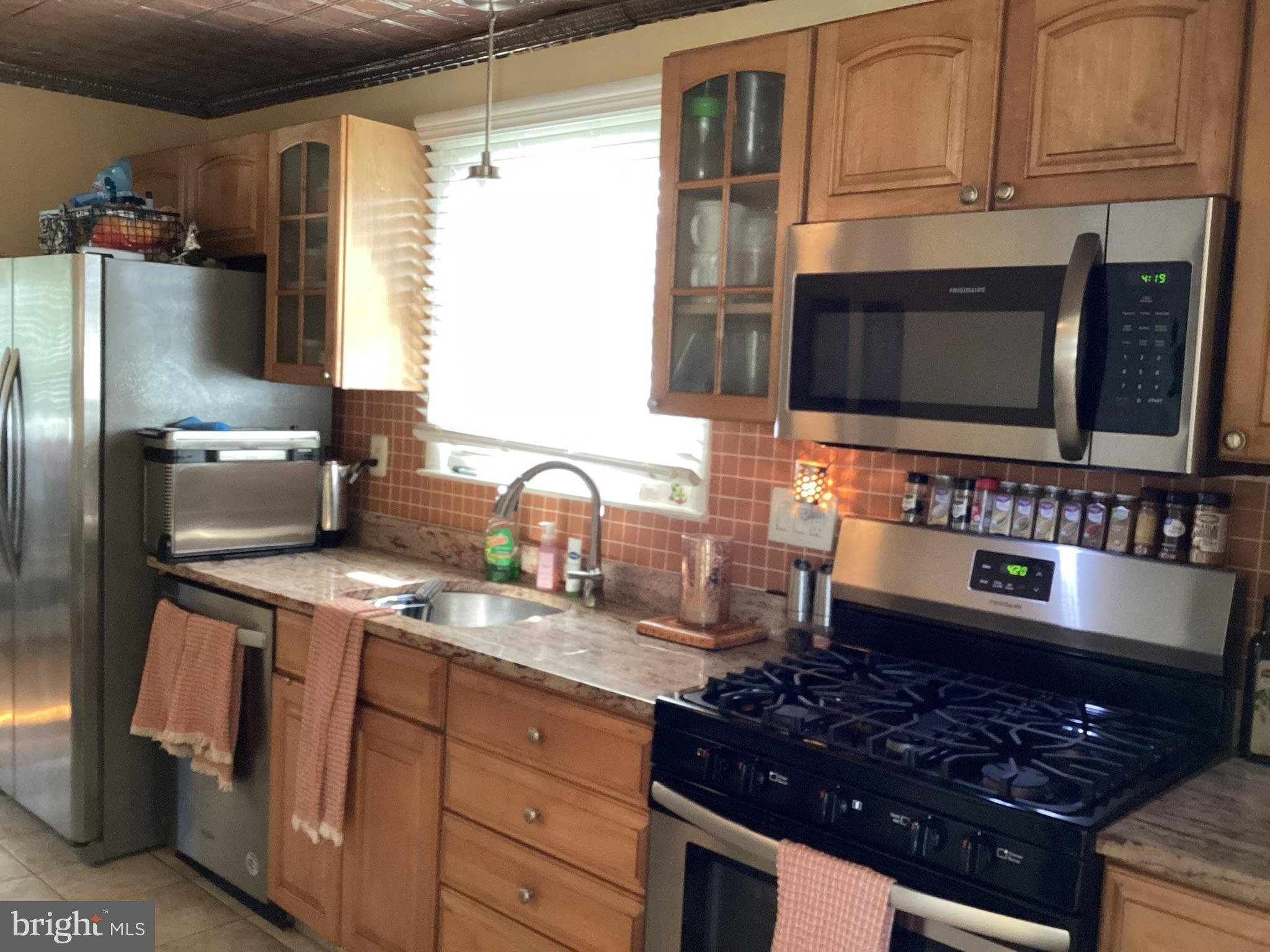 1101 Prospect Lane Somerdale, NJ 08083 - Photo 7 of 41 a kitchen with stainless steel appliances granite countertop a sink stove and refrigerator