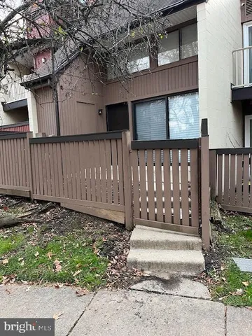 a view of small garden with wooden fence