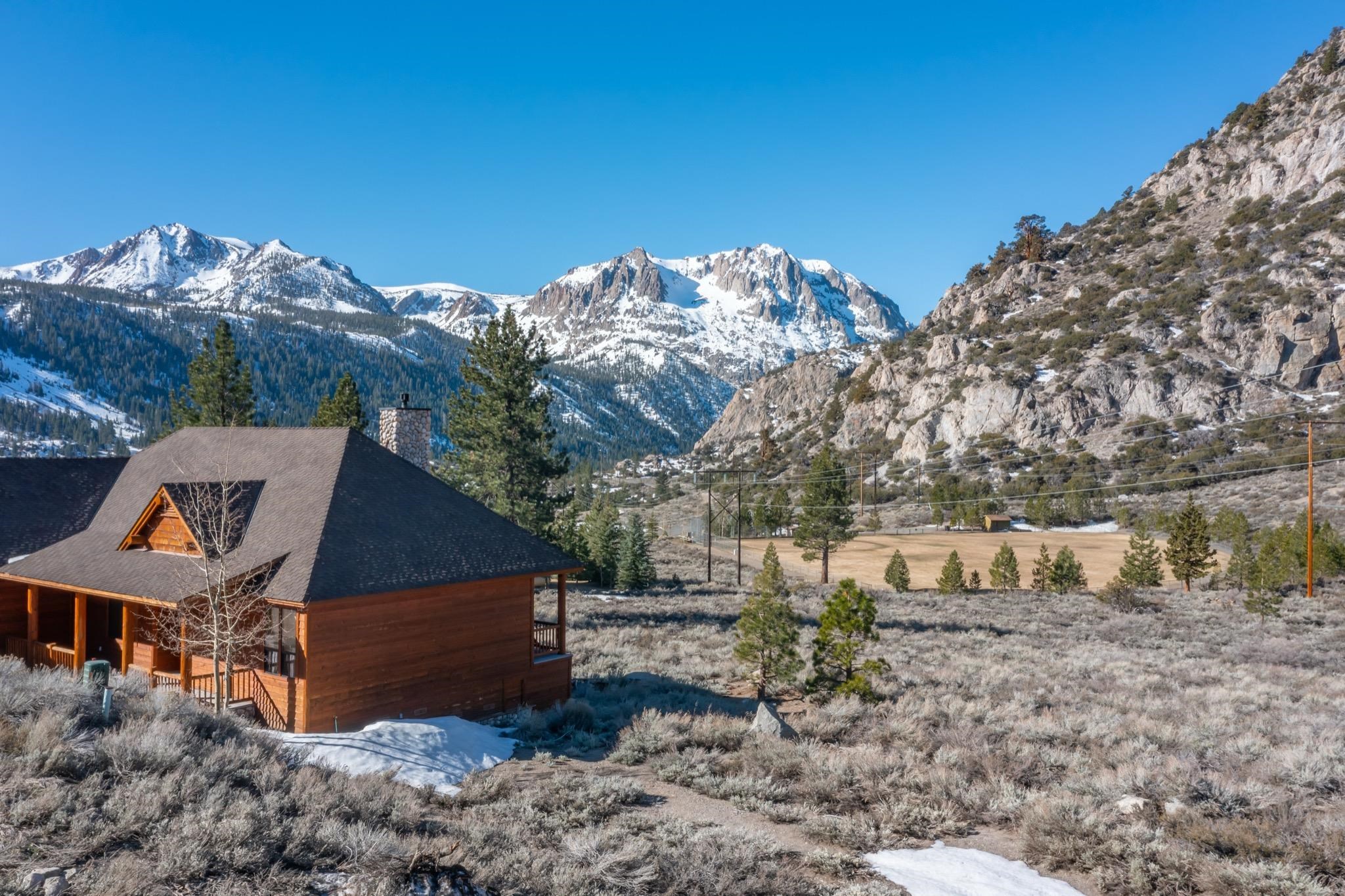 43 Highland Place June Lake, CA 93529 - Photo 8 of 24 a front view of a house with a yard and mountain