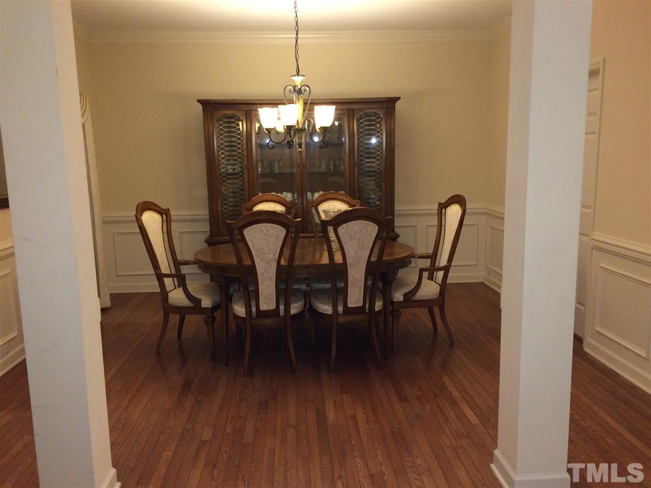 3405 Pritchard Court Raleigh, NC 27616 - Photo 6 of 11 a dining room with furniture wooden floor a rug and a chandelier
