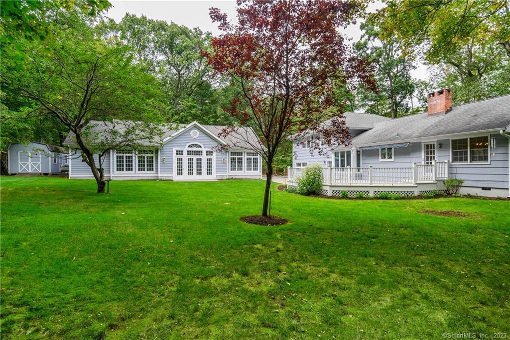a house with green field in front of it