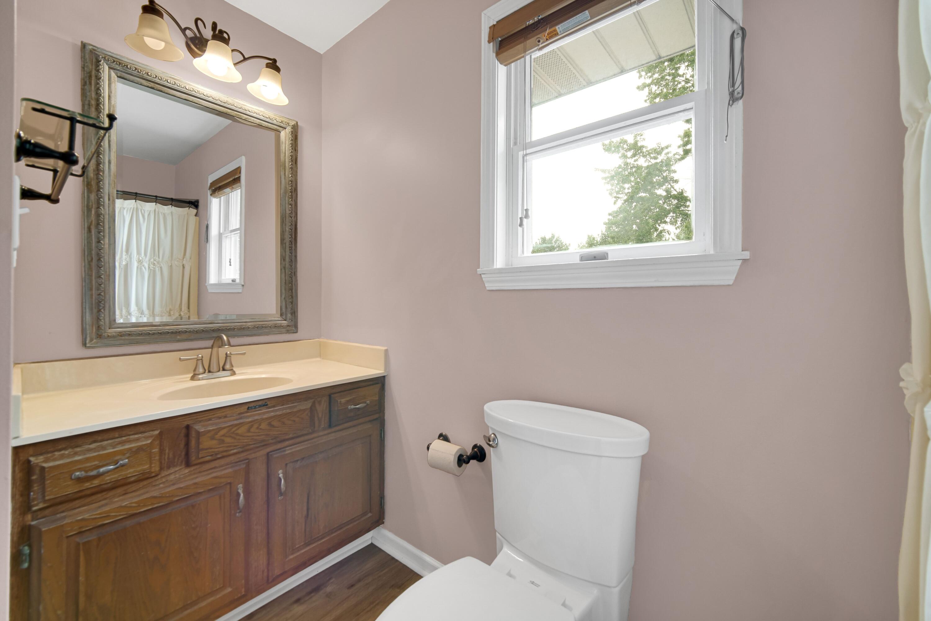 476 Highway 2 Hebron, IN 46341 - Photo 18 of 25 a bathroom with a granite countertop toilet sink and mirror