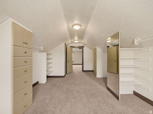 1279 West 1500th Street North Mapleton, UT 84664 - Photo 49 of 83 Spacious walk-in closet featuring built-in cabinetry, integrated drawers, shelving units, full-length mirror, and neutral-tone carpeting