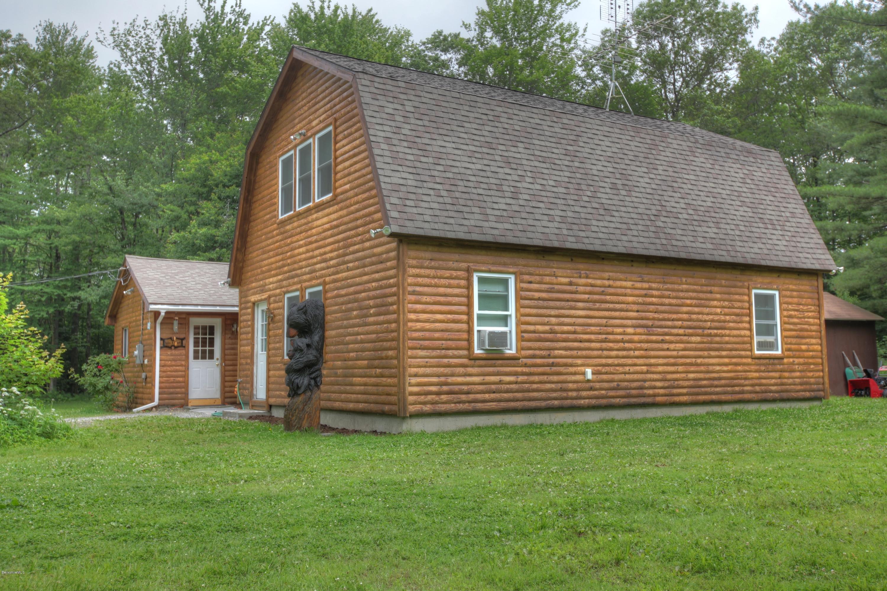 a view of a house with a backyard
