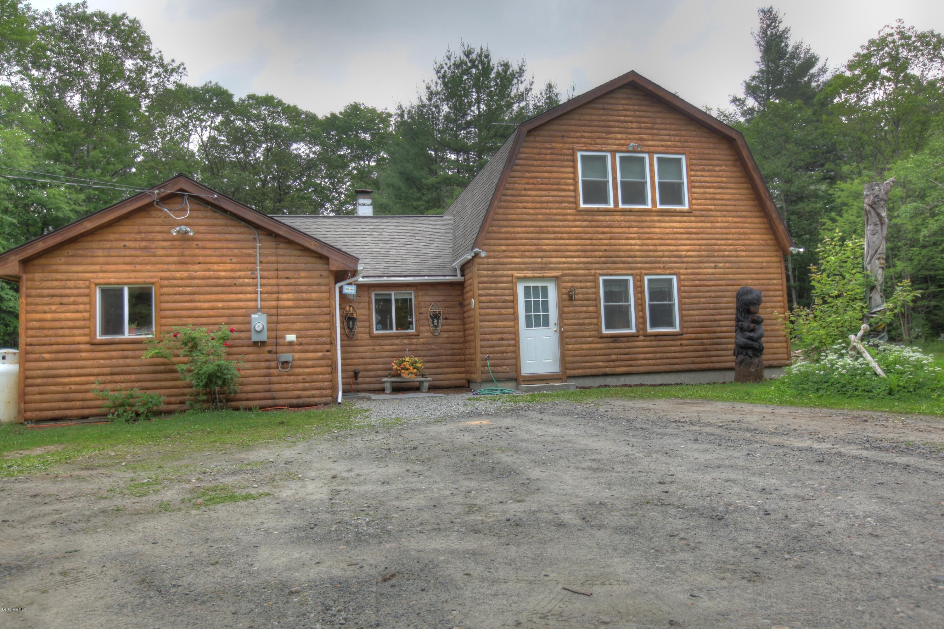 702 Becket Road Otis, MA 01029 - Photo 2 of 22 a view of a house with a yard and garage