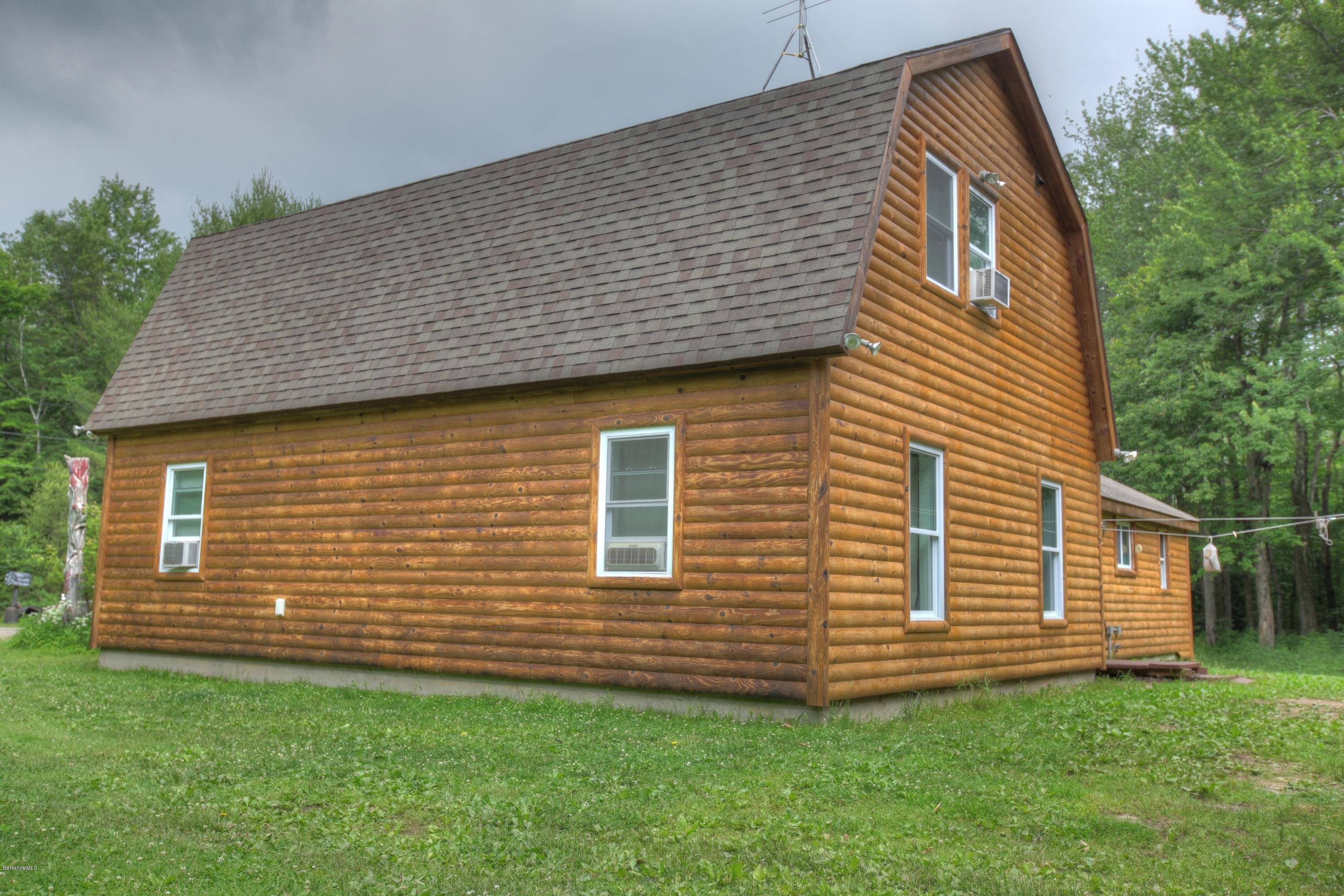 702 Becket Road Otis, MA 01029 - Photo 11 of 22 a front view of a house with a garden