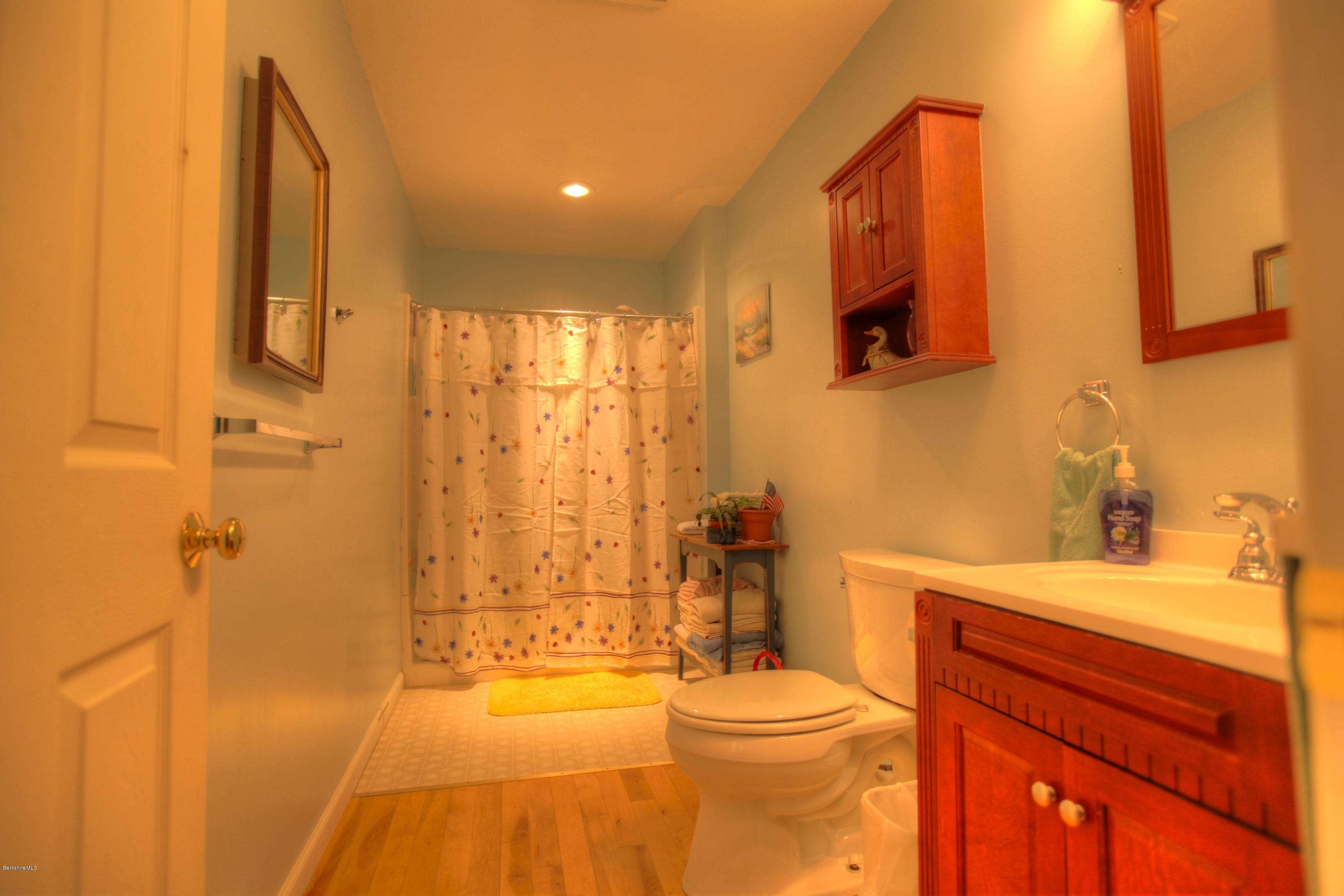 702 Becket Road Otis, MA 01029 - Photo 17 of 22 a bathroom with a sink a toilet and shower