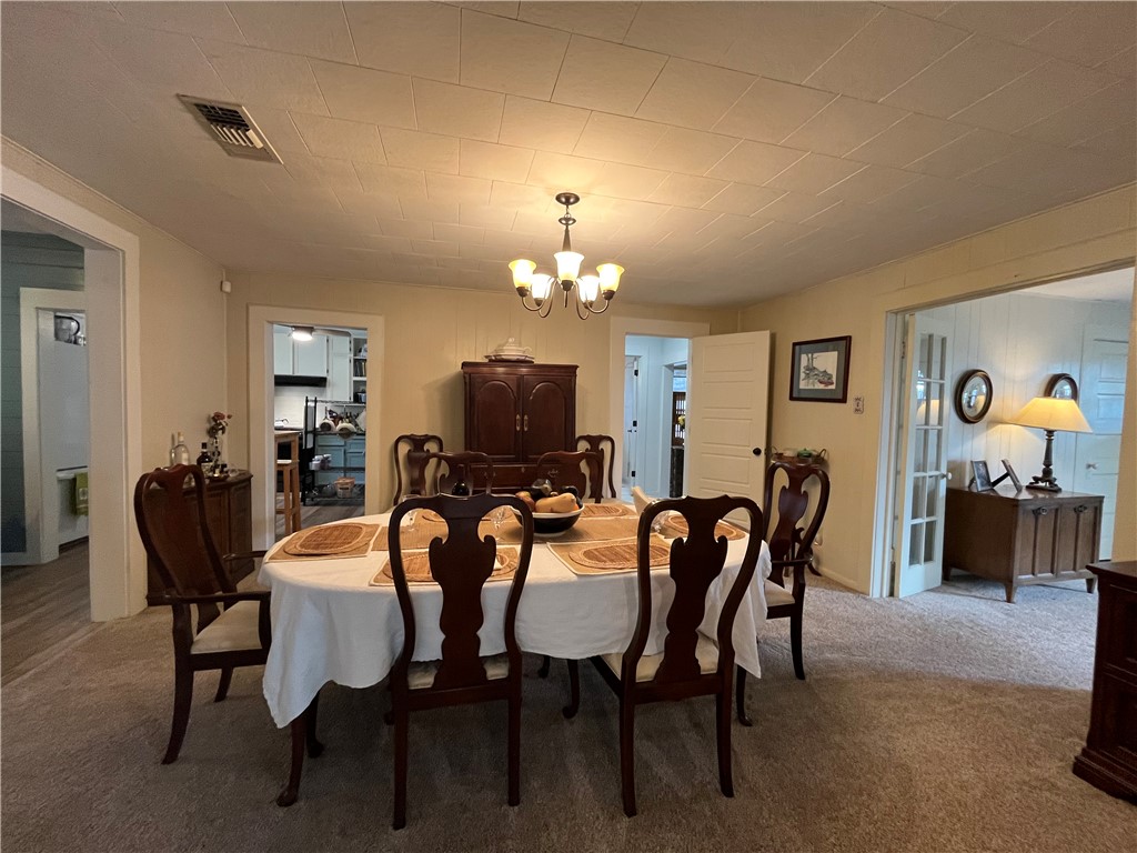 1102 North Travis Avenue Cameron, TX 76520 - Photo 17 of 48 a view of a dining room with furniture and chandelier