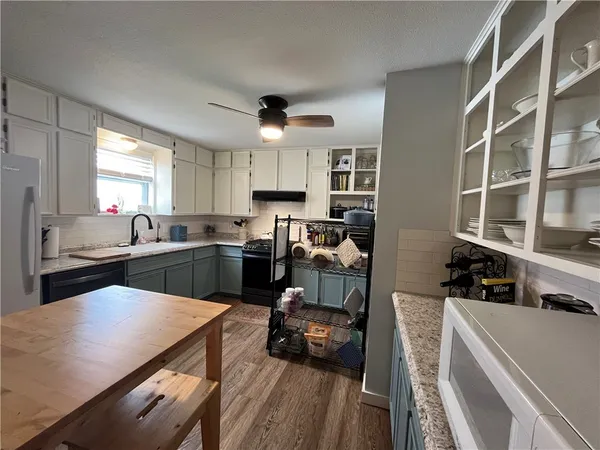 a kitchen with a sink a stove and a refrigerator