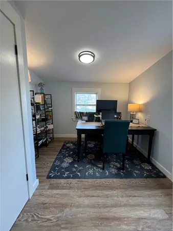 a workspace with furniture and a wooden floor