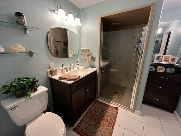 a bathroom with a sink vanity granite and toilet