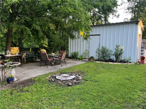 a view of a backyard with sitting area