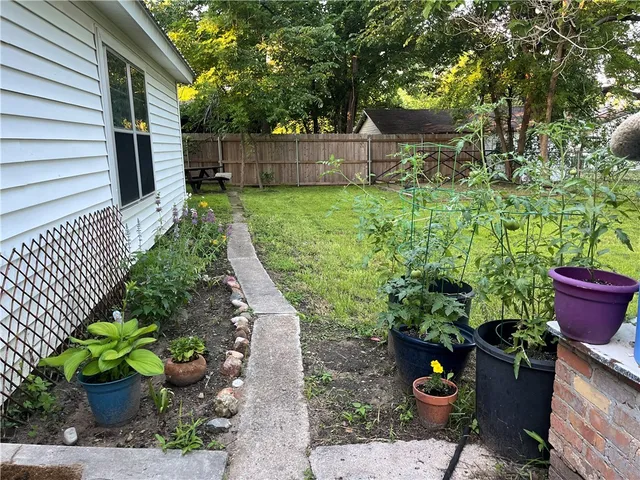 a view of a backyard with potted plants