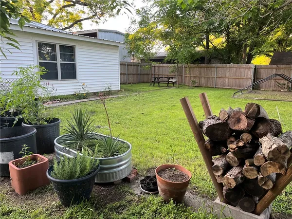 a view of a backyard with sitting area and a garden