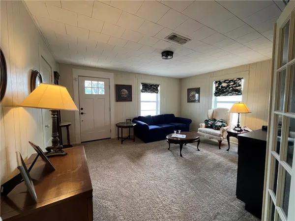 a living room with furniture a window and a flat screen tv