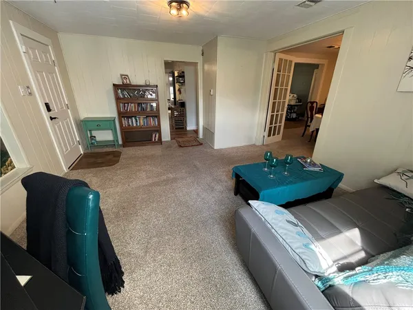 a living room with furniture and a mirror