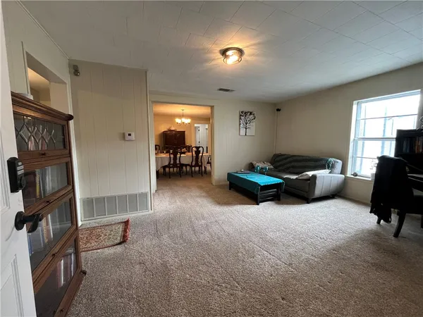 a living room with furniture a window and gym equipment