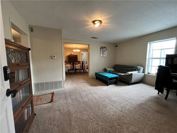 a living room with furniture a window and gym equipment