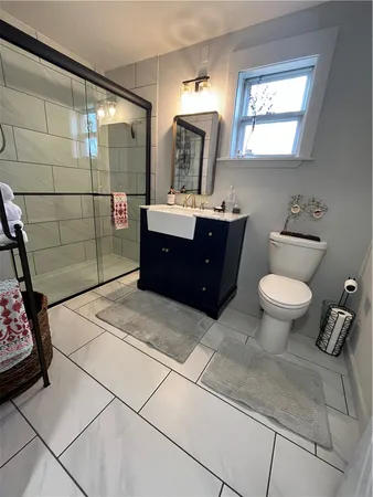 a bathroom with a sink toilet and shower